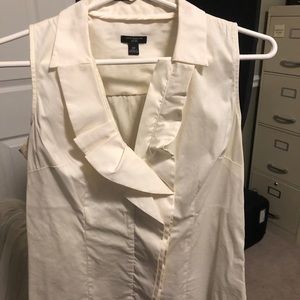 Sleeveless white ruffle blouse